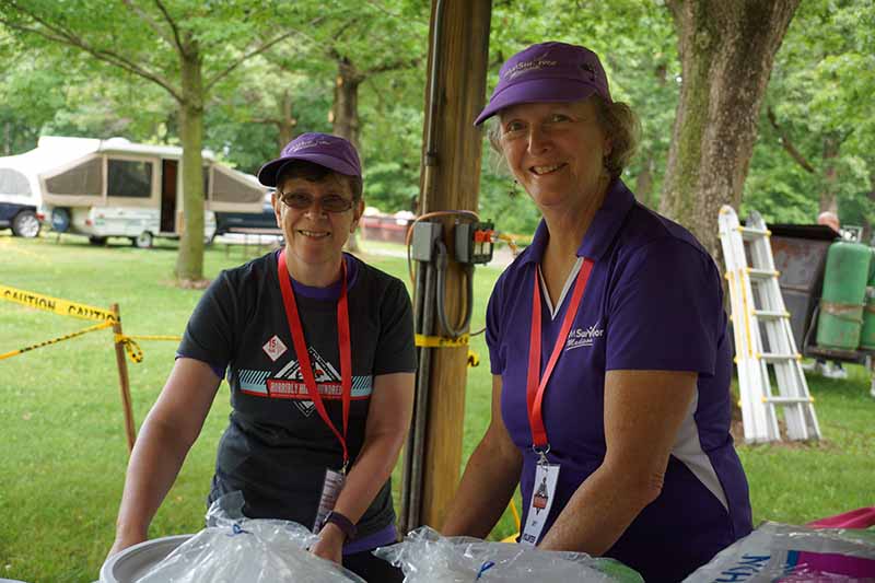 Volunteers help serve food during the event.